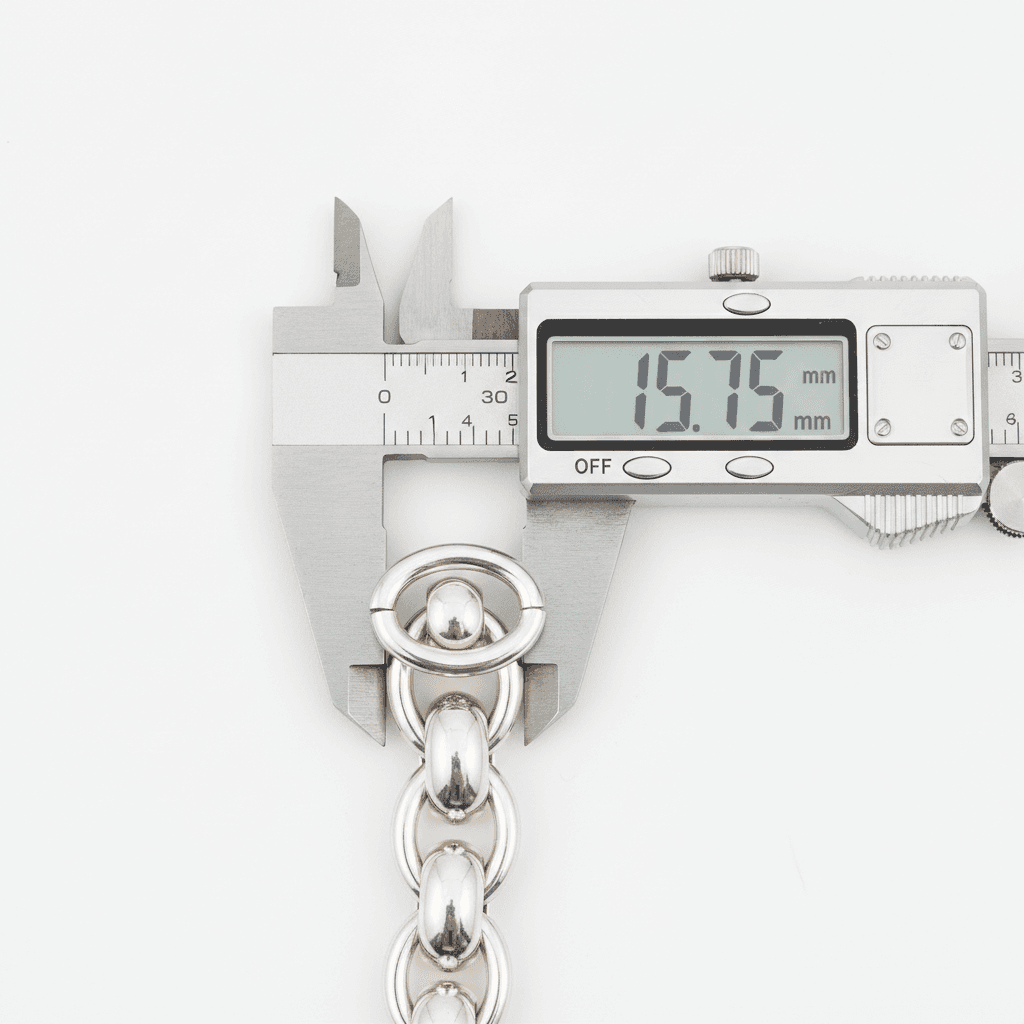 Digital calipers measuring a silver chain link at 15.75 millimeters
