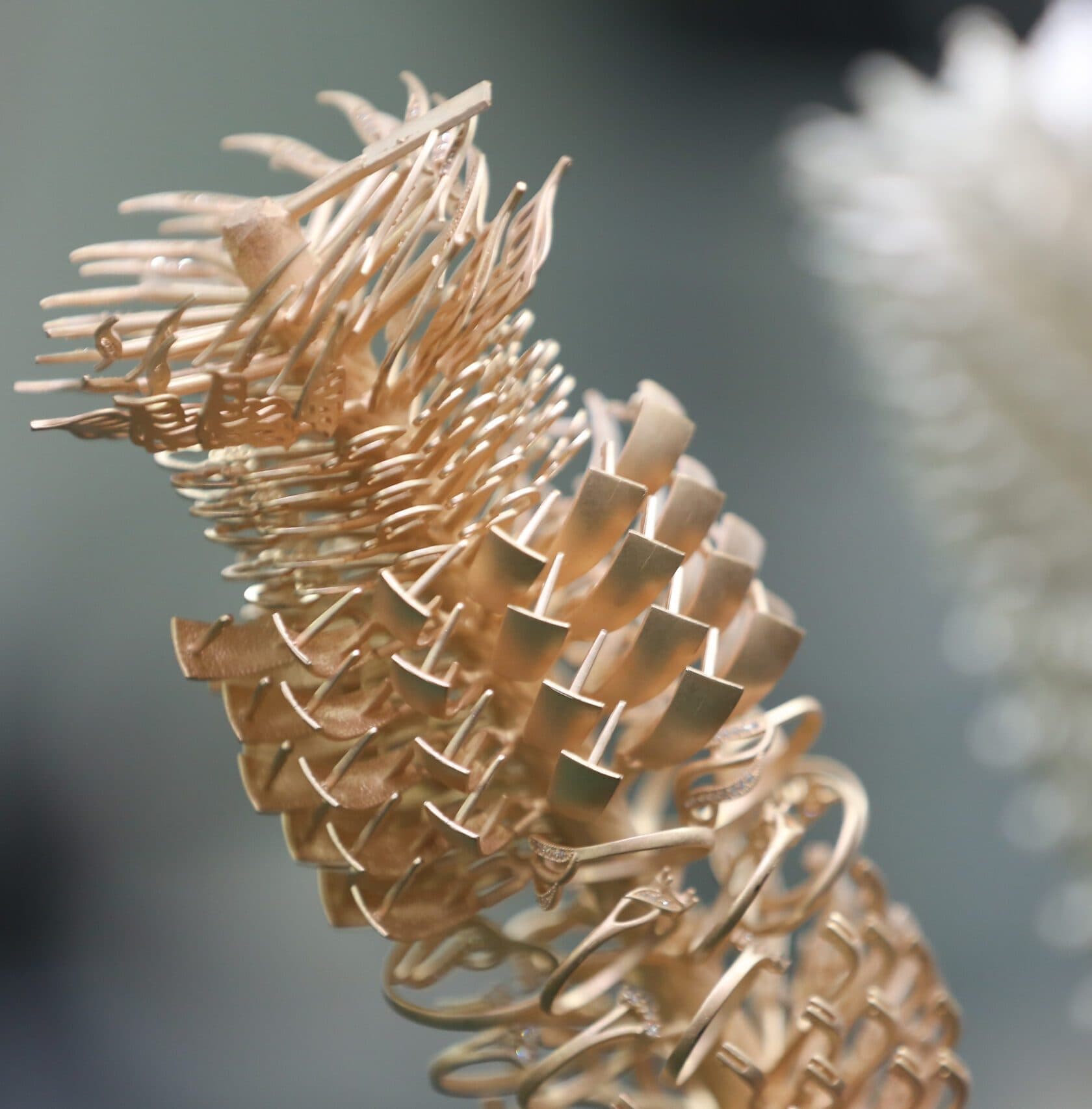 Cluster of rose gold jewelry blanks stacked together in a pine cone shape
