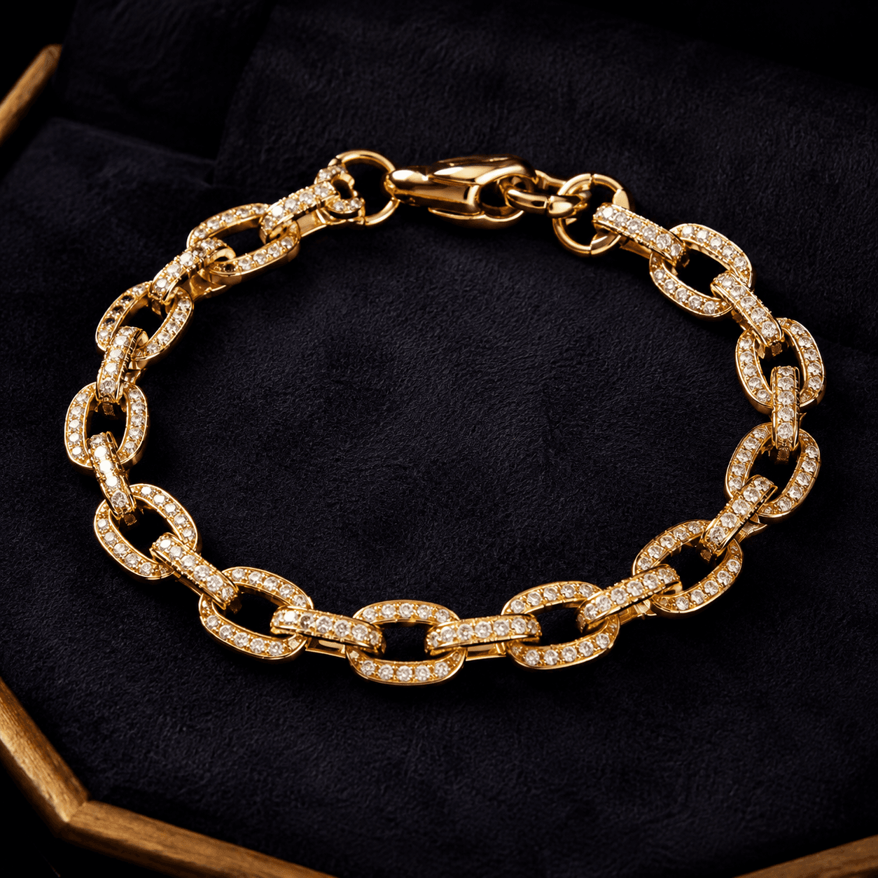 An elegant gold and diamond bracelet laid flat on a dark velvet tray, overhead shot, warm studio lighting highlighting the